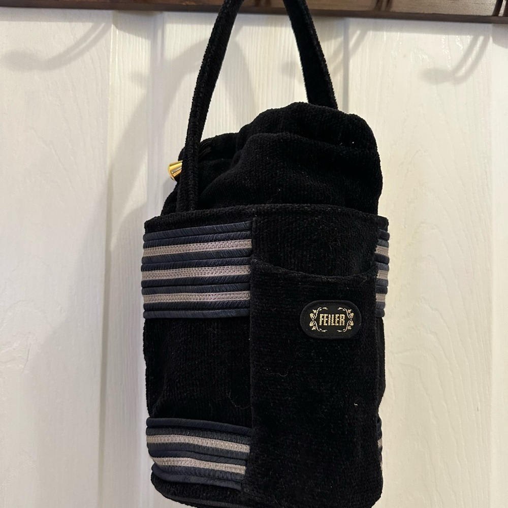 Black Satchel with Striped Accents and Plush Texture